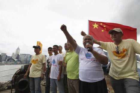 Activists shout slogans while departing for the disputed islands Senkaku in Japan, or Diaoyu in China, in Hong Kong